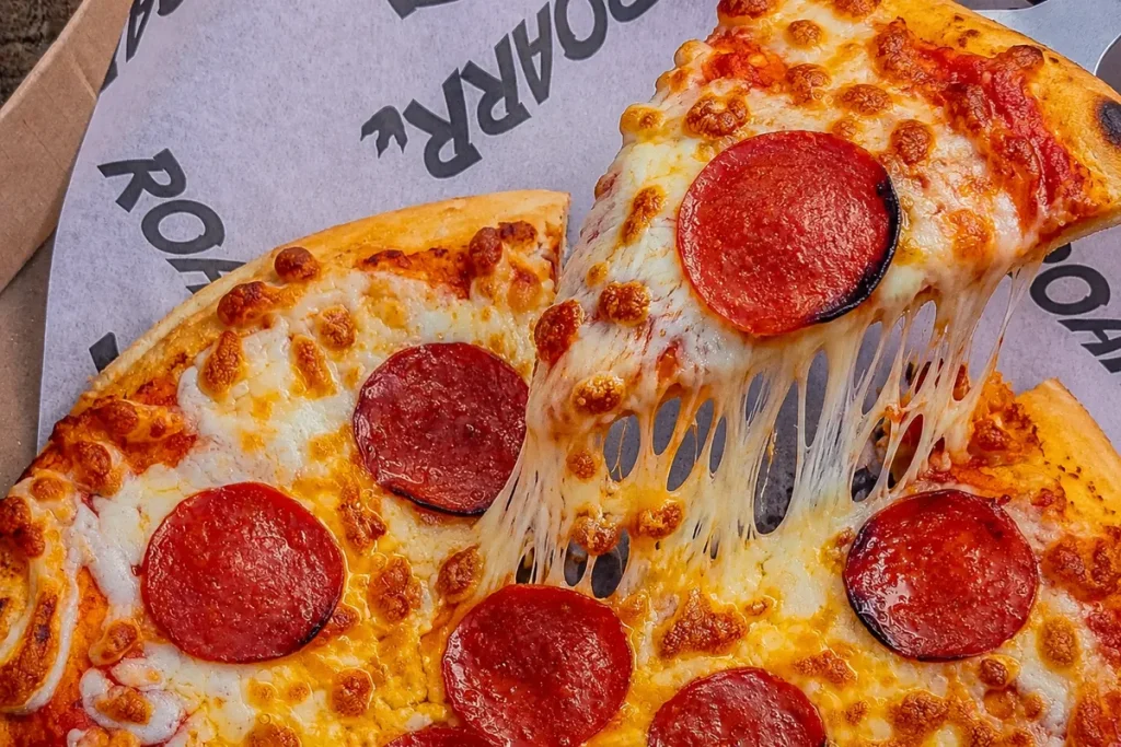 Freshly baked pepperoni pizza on ROARR! branded paper